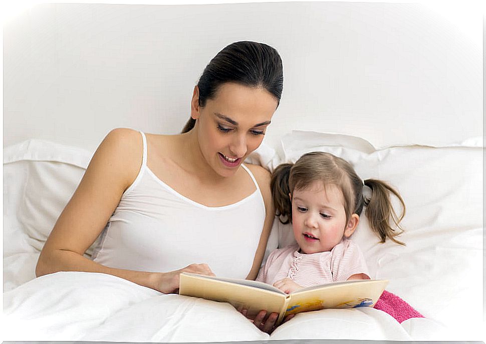 Mother teaching her daughter to read.
