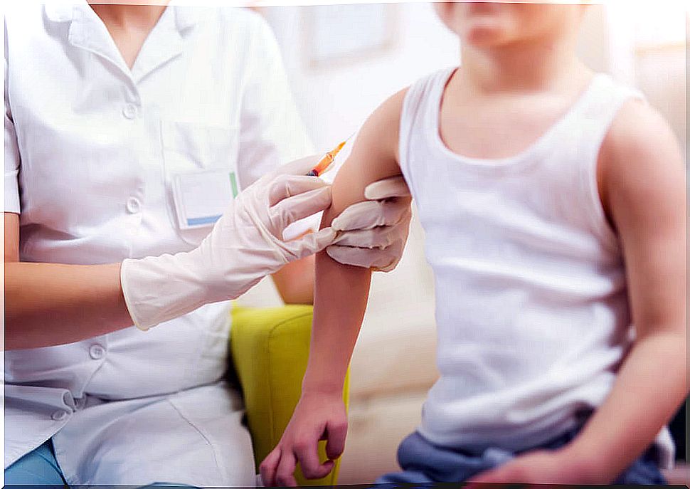Child being vaccinated by a nurse.