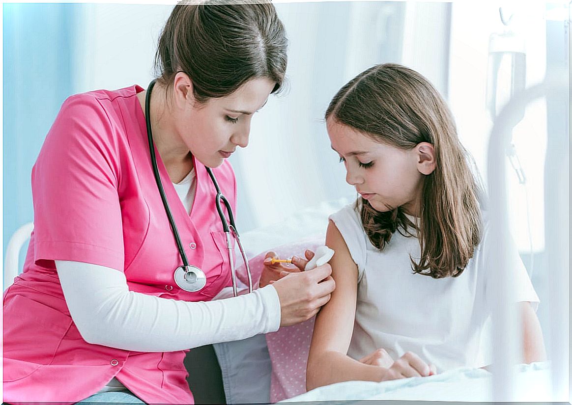 Girl receiving vaccination by a nurse because it is important to vaccinate children.