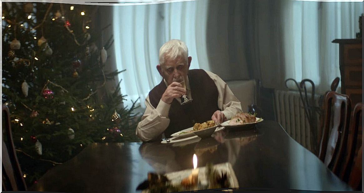 Elderly man eats alone.