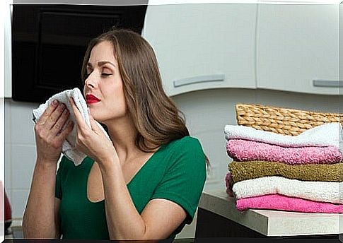 woman smelling clothes with fabric softener
